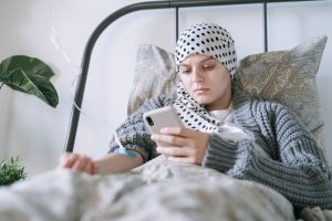 a cancer patient looking through her phone